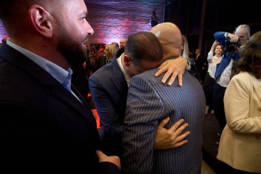 Bucharest, Romania. 19th Nov, 2025: Daniel Baluta (L), mayor of Sector 4, hugs Cristian Popescu Piedone (R), former mayor of Sectors 4 and 5, during the launch of his candidacy for general mayor of Bucharest.