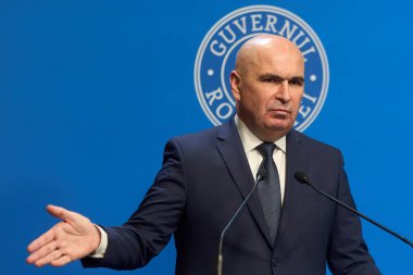 Bucharest, Romania. 21st Nov, 2025: Ilie Bolojan, Prime Minister of Romania, holds a press conference at Victoria Palace, the Romanian Government headquarters.