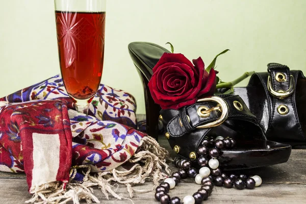 Shoes and scarf with a rose and wine on the old wooden background — Stock Photo, Image