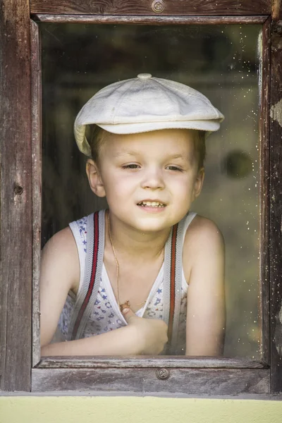 Boy looking at a window — Stock Photo, Image