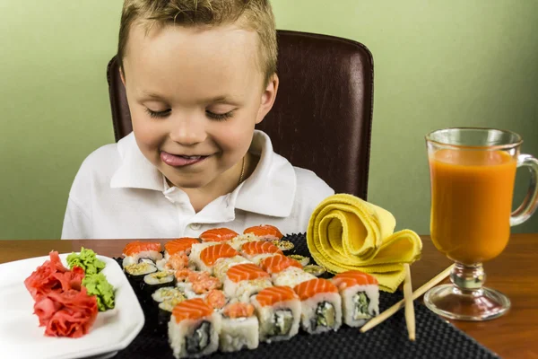 Funny boy eating sushi — Stock Photo, Image
