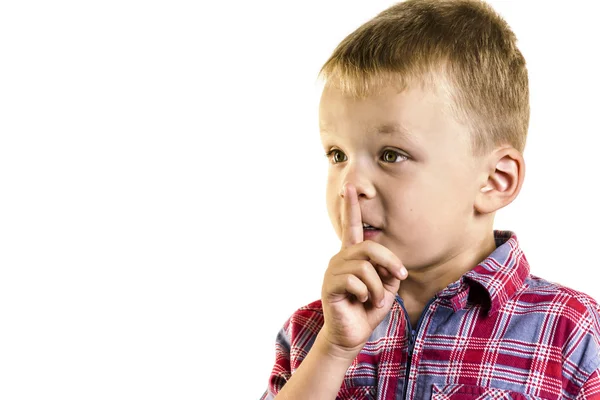 Boy holding a finger to lips — Stock Photo, Image