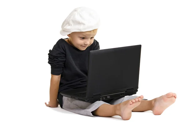 Boy plays at a laptop — Stock Photo, Image