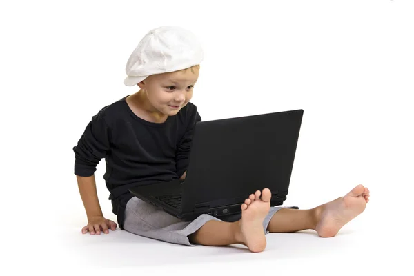 Boy plays at a laptop — Stock Photo, Image