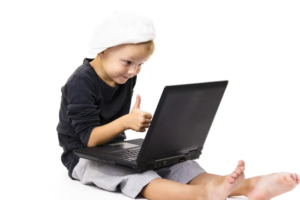Cute boy playing laptop — Stock Photo, Image