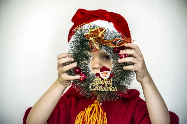 Boy and Christmas wreath — Stock Photo, Image