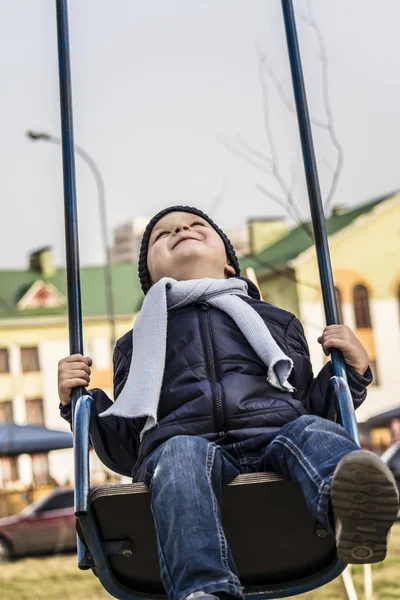 Boy riding on a swing — Stock Photo, Image