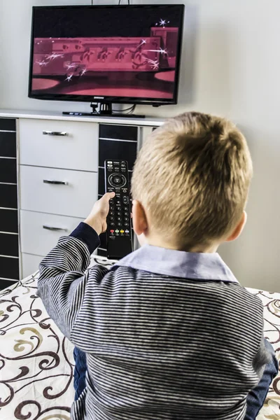 Child watches TV, remote control TV