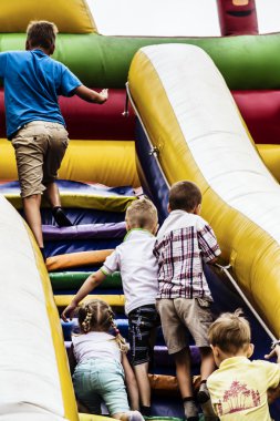 Children playing on a hill in the park air