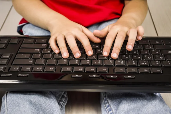 The boy 's hands pressed the keys of computer keyboards — стоковое фото