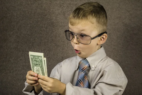 Niño sorprendido dólares — Foto de Stock