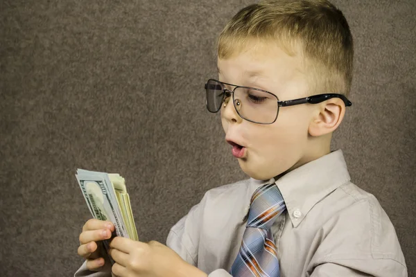 Niño sorprendido dólares — Foto de Stock