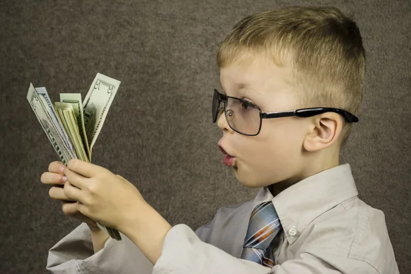 Niño sorprendido dólares — Foto de Stock