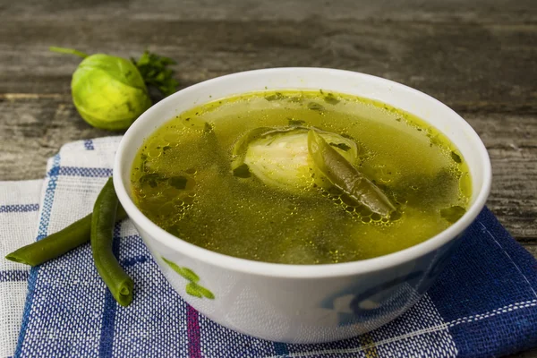 Green soup on a wooden table — Stock Photo, Image