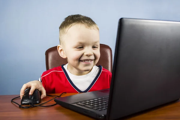 Boy plays at a laptop — Stock Photo, Image