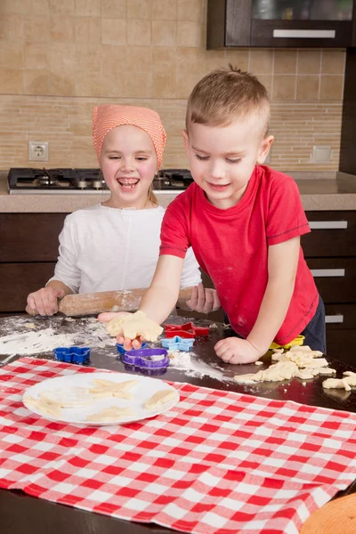 Children enthusiastically bake cookies — Stock Photo, Image