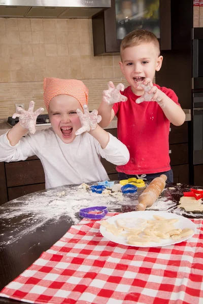 Children enthusiastically bake cookies — Stock Photo, Image