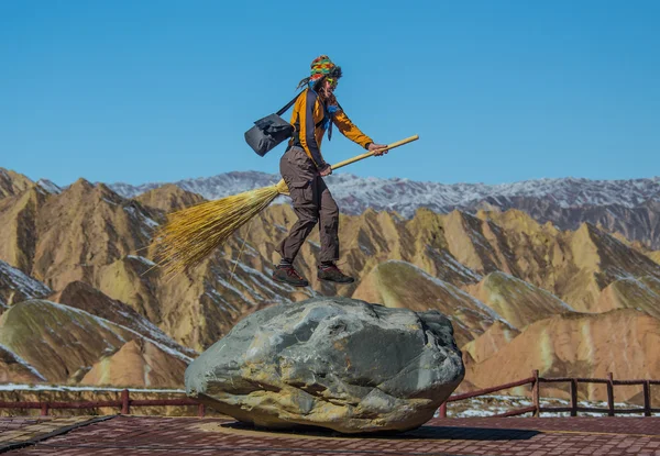 Man with broom sweeping fallen leave — Stock Photo, Image