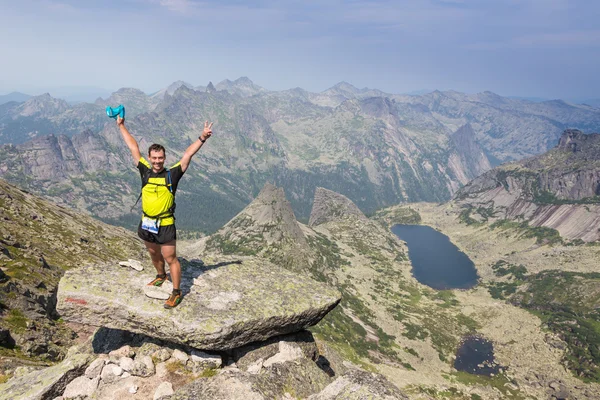 Man on the top of  hill watching wonderful scenery in mountains during summer