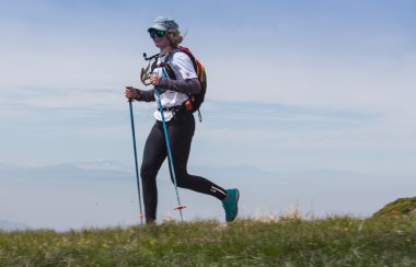 ALMATY, ALMATY DISTRIKT,KAZAKHSTAN - MAY 22, 2016: Open competition SKY RANNING 2016 held in Eliksay gorge. A girl runs up to the mountain named Bukreeva participating in the competition