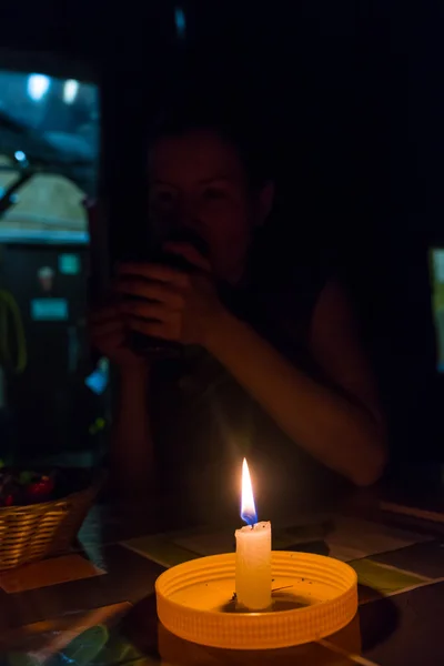 Sad little girl with a candle — Stock Photo, Image