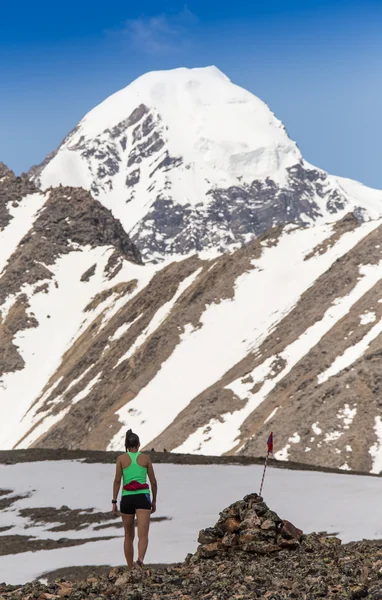 Female running in mountains under sunlight.