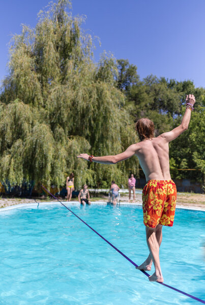 People walk on the sling over the water