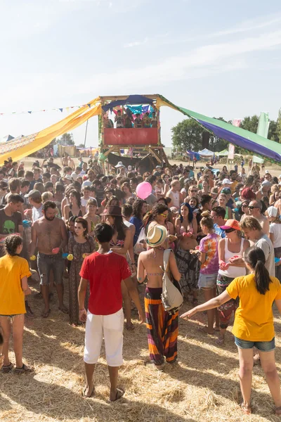 A large number of people in the colorful outdoor festival