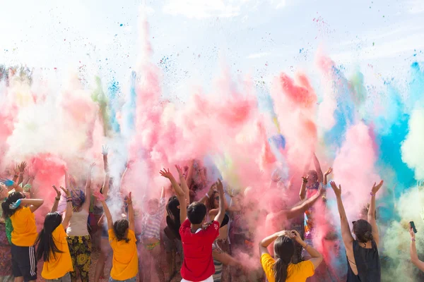 A crowd of people dancing on a colorful festival of colors Royalty Free Stock Photos