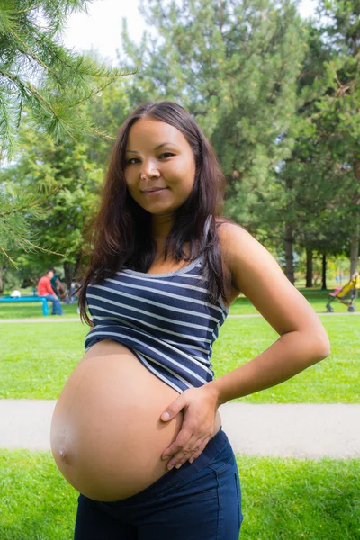 Gravid flicka promenader i parken — Stockfoto