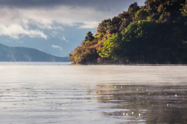 Beautiful lake at sunrise in autumn mountains — Stock Photo, Image