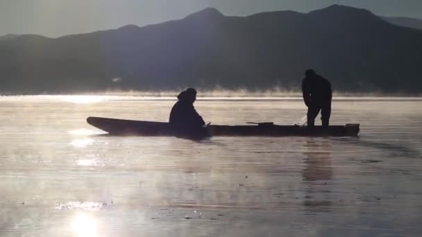 Fishermen pulling net in the rays — Stock Video