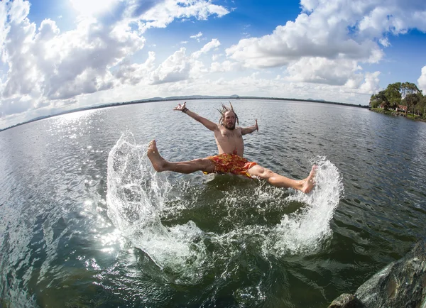 Teenage boy jumping in the river — Stock Photo, Image