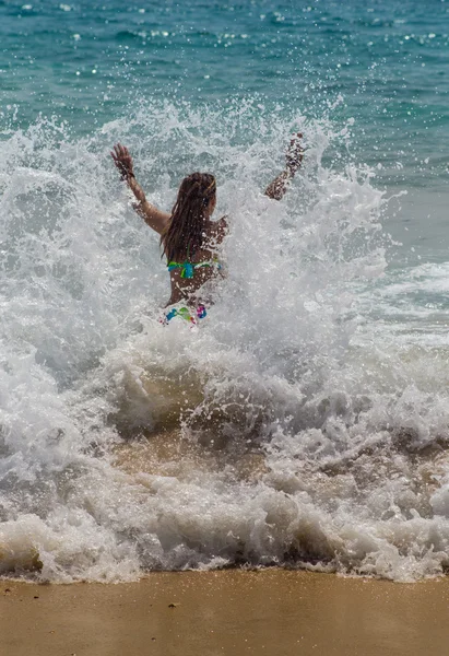 Fille rire et pleurer dans la pulvérisation des vagues à la mer par une journée ensoleillée — Photo