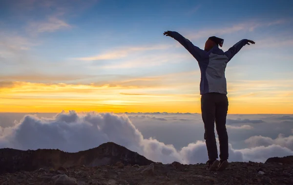 Happy girl jumping on the mountain in sunset time — Zdjęcie stockowe