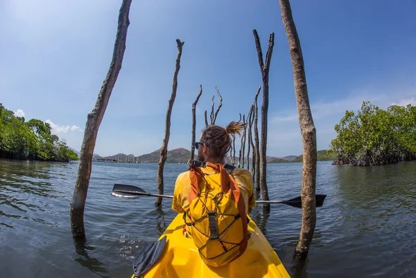 Junge Frau paddelt hart im Seekajak mit vielen Spritzern — Stockfoto