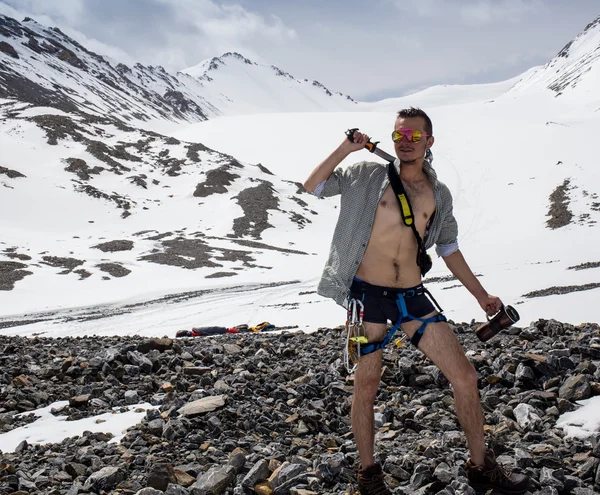 Man in swimming trunks but with climbing equipment — Stock Photo, Image