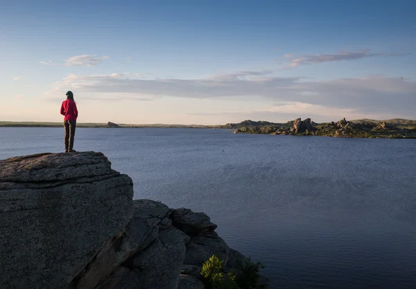 Young woman sitting on rock and enjoying beautiful view — Stock Photo, Image