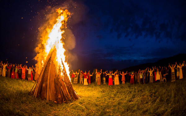 People celebrate the holiday and Russian dance in a circle around  sacred fire