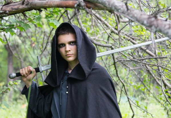 Portrait of a beautiful young warrior holding sword — Stock Photo, Image