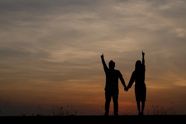 Silueta hombre y mujer con hermoso el cielo al atardecer —  Fotos de Stock