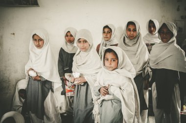SKARDU, PAKISTAN - APRIL 18: An unidentified Children in a village in the south of Skardu are learning in the classroom of the village school April 18, 2015 in Skardu, Pakistan. clipart
