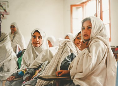 SKARDU, PAKISTAN - APRIL 18: An unidentified Children in a village in the south of Skardu are learning in the classroom of the village school April 18, 2015 in Skardu, Pakistan. clipart