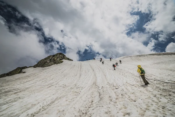 Groupe de touristes marchant dans une plaine d'hiver — Photo