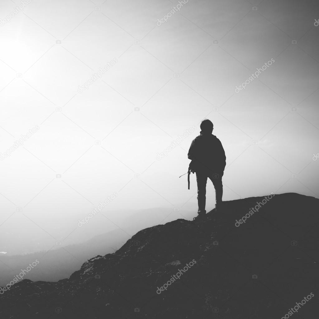 Male mountain climber standing on top