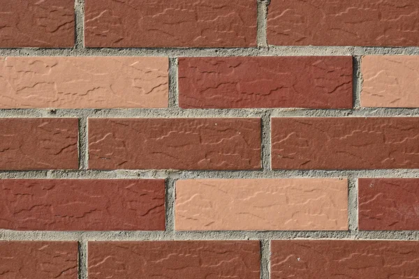 Wall made of red and pink bricks — Stock Photo, Image