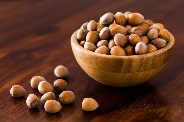 Hazelnut in wooden bowl Royalty Free Stock Photos