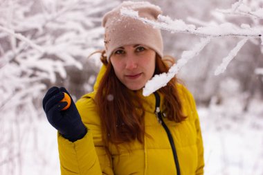 Açık havada, sarı ceketli ve uzun saçlı, mandalina kollu güzel seksi bir kadının portresi. Yüksek kalite fotoğraf