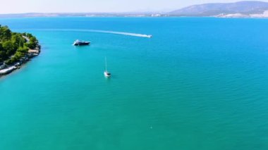 Didim, Türkiye 'deki Akbuk Körfezi' nde mavi Ege Denizi ile çevrili bir sürat teknesini takip eden insansız hava aracı