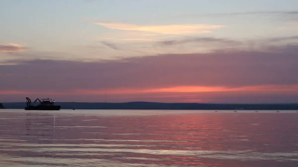 Orange gold sunset on sea surface. Sun reflection on water. Landscape under colorful sky at sunset. Orange sundown reflecting from calm Aegean sea at golden hours.